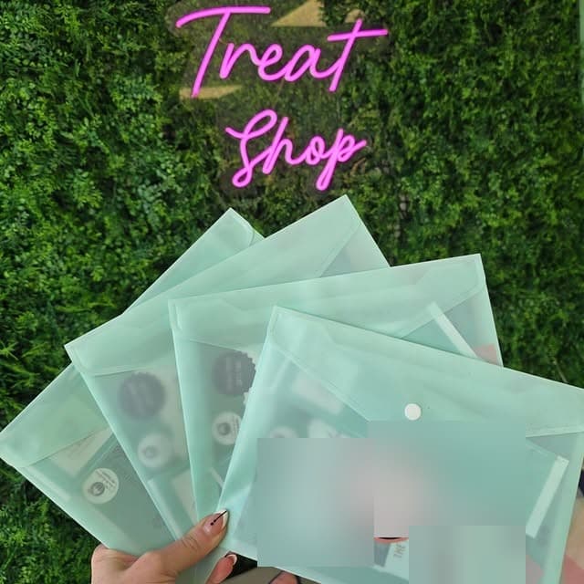 The neon Treat Shop sign above letterbox treat packs